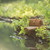 This is a tan brown leather toiletry bag by water.