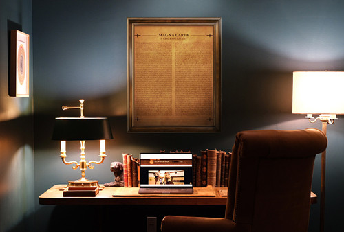 This is a framed copy of The Magna Carta burned into a large panel of aged looking tan leather hanging on an office wall.
