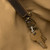 This is the key clip view of the leather all in one backpack in dark coffee
