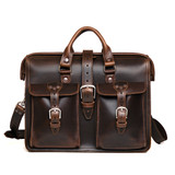This is the dark coffee brown flight bag leather briefcase with two front pockets, two handles, and a shoulder strap. Made by Saddleback