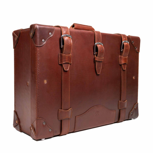 Side view of the chestnut medium suitcase in the grandfather collection. Displaying the buckles and handle that have been meticulously crafted to last 100 years. Made by Saddleback