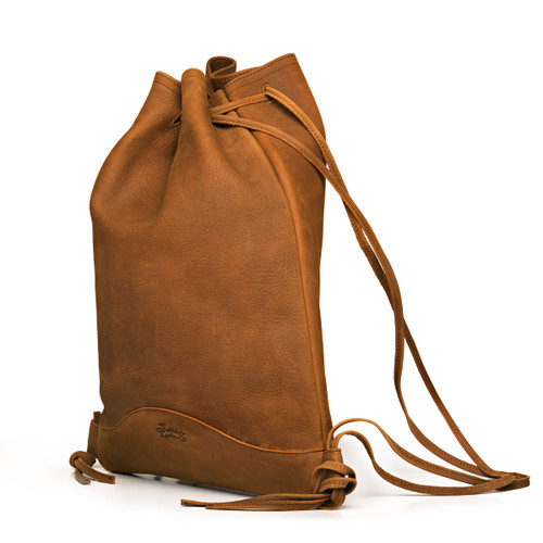 This is the closed drawstring flat backpack made of full grain leather in the color tobacco. Made by Saddleback
