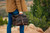Membership bag with the top rolled down being carried in the Colorado mountains.