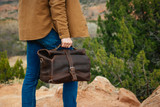 Membership bag with the top rolled down being carried in the Colorado mountains.