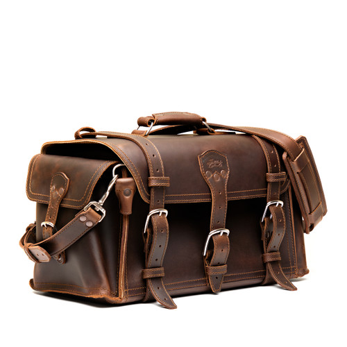 Dark coffee brown side pocket duffle from the front. Made from full grain leather (toughest there is) and reinforced with rivets on any stress points. Made by Saddleback Leather