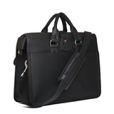 This is the backside of the black flight bag leather briefcase showing the shoulder strap and two handles for easy carry. Made by Saddleback