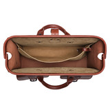 Inside of the leather flight bag briefcase in the color red brown leather flight bag briefcase showing off the gladstone closure. Made by Saddleback