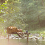 Here is the doctors leather duffle bag out by a river. Made by Saddleback