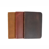 3 of the pocket notebooks stacked over each other in the colors tobacco, chestnut,  and dcb.