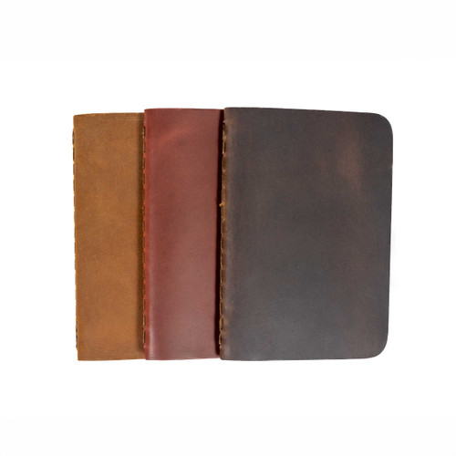 3 of the pocket notebooks stacked over each other in the colors tobacco, chestnut,  and dcb.