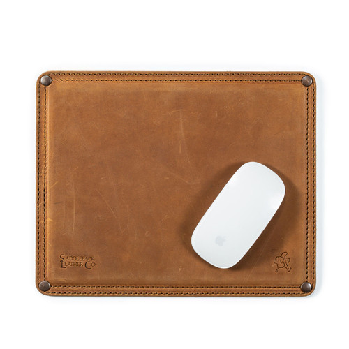 This is a tan brown leather mouse pad with a mouse on it. It has stitching around the edges and neoprene in the middle.