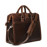 This is the backside of the flight bag leather briefcase showing the shoulder strap and two handles for easy carry. Made by Saddleback