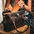 A leather purse with a Gladstone closure shown open.