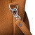 A light tan leather purse with a removable strap.