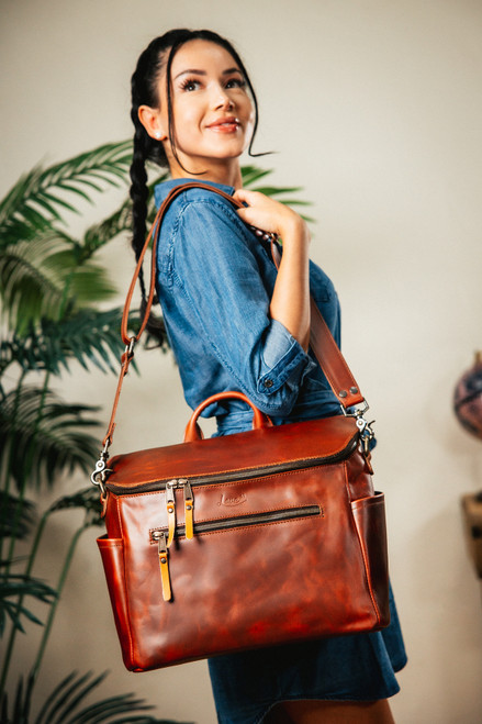 The side of the chestnut colored bag in lifestyle