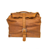 Overnight bag in tobacco with the top rolled down and buckled. Made by Saddleback