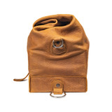 Side of the overnight bag in tobacco with the top rolled down and buckled. Made by Saddleback