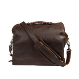 Back of the dark coffee brown overnight bag with the shoulder strap hooked up. Made by Saddleback