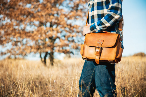 Here is a model with a rounded satchel on in front of a fall tree. Made by  Saddleback