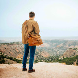 14" Leather Overnight Bag in tobacco leather being worn crossbody.