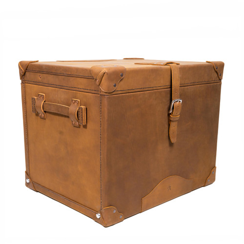 Tobacco colored small trunk laid down and showing the details in the handles and buckle closures. Made by Saddleback